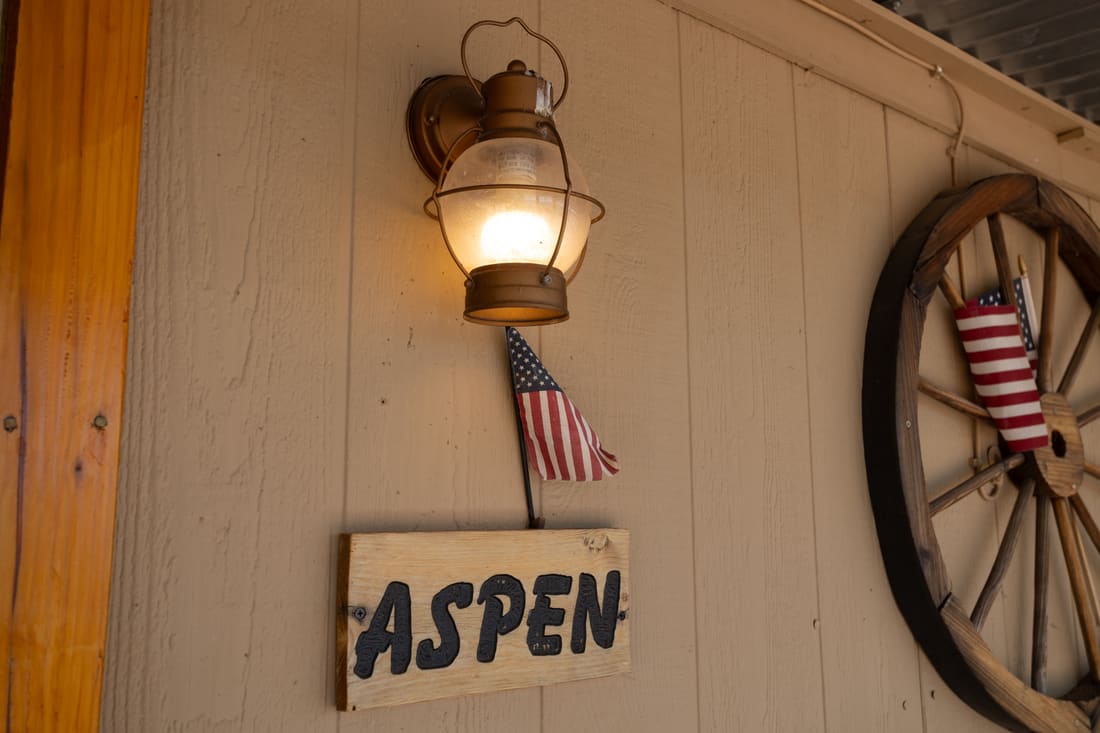 The hand-painted Aspen sign on the cottage door