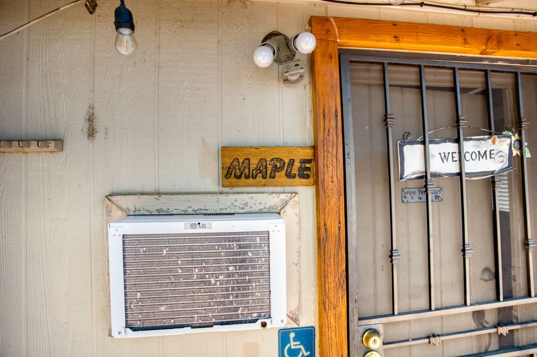 The hand-painted Maple sign on the cottage door