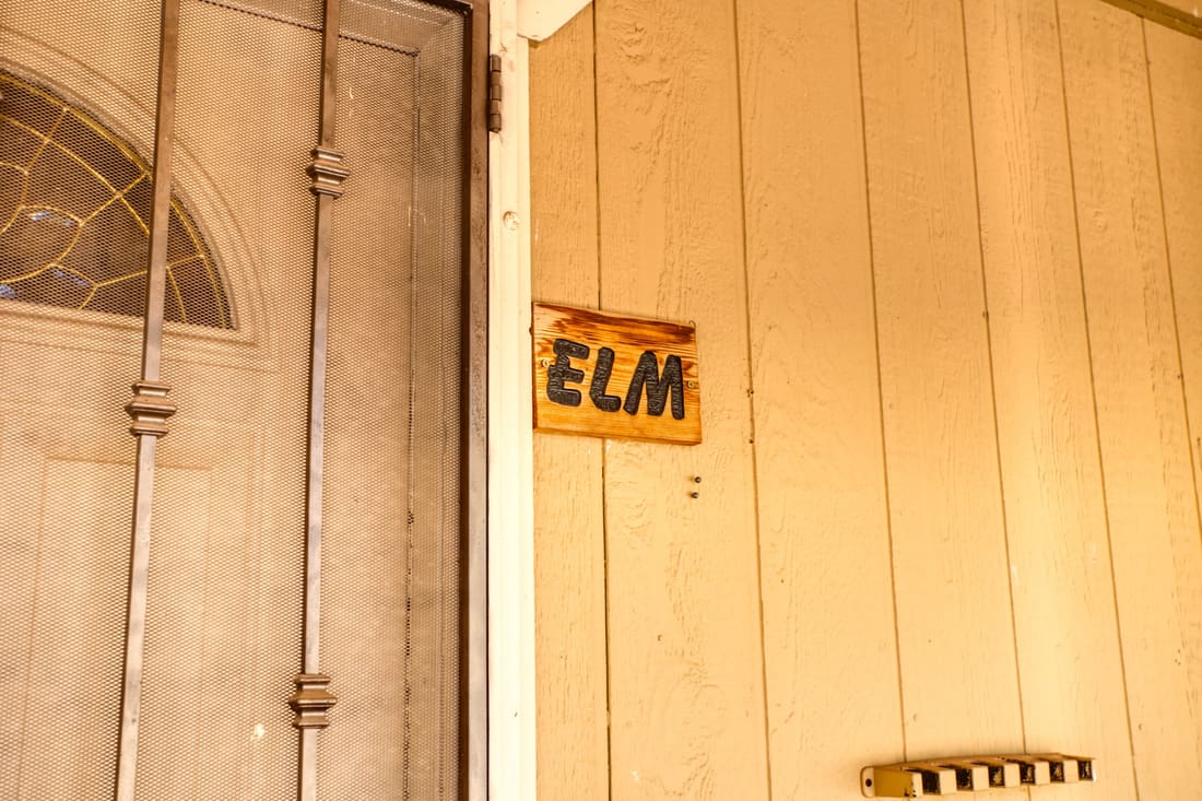 The hand-painted Elm sign on the cottage door