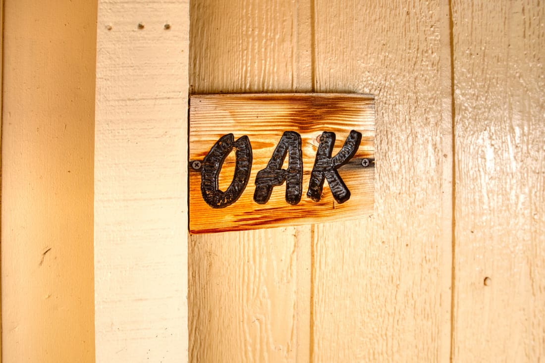 The hand-painted Oak sign on the cottage door